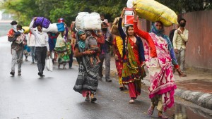 Migrant workers head home from New Delhi after the national lockdown took effect.